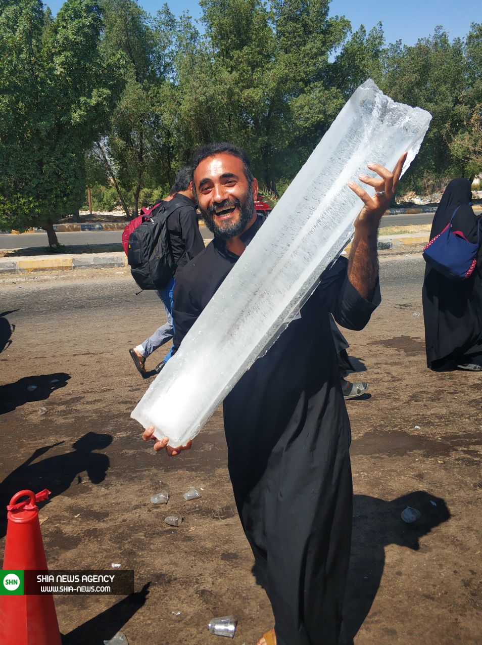 تصاویر/ تلاش عراقی‌ها برای زائران در گرمای ۵۰ درجه